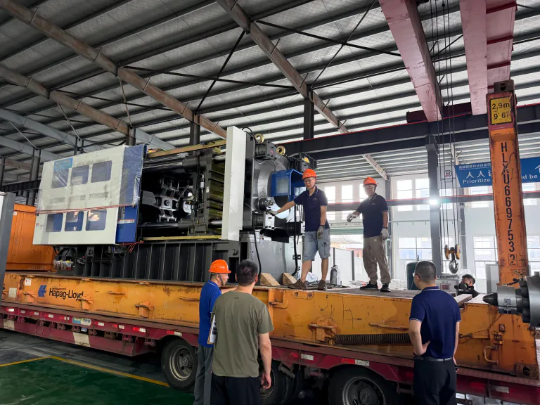 BEST Machine team loading an injection molding machine for delivery